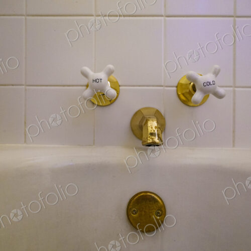 Close-up of old-fashioned bathtub faucet and drain. Close-up of old-fashioned bathtub faucet and drain.