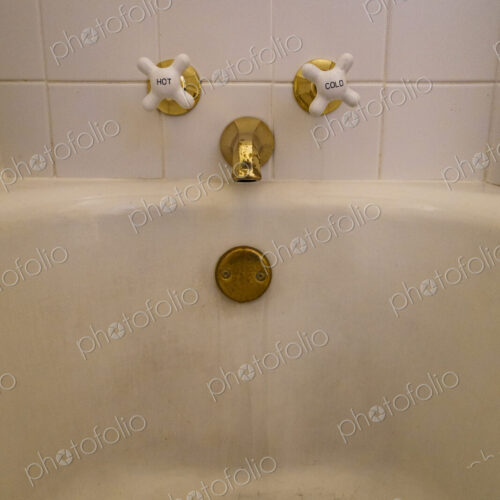 Close-up of old-fashioned bathtub faucet and drain Close-up of old-fashioned bathtub faucet and drain