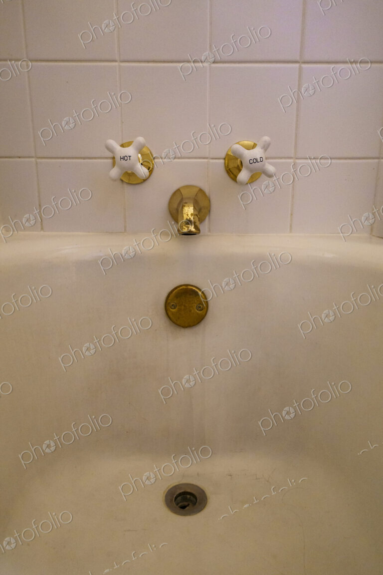 Close-up of old-fashioned bathtub faucet and drain