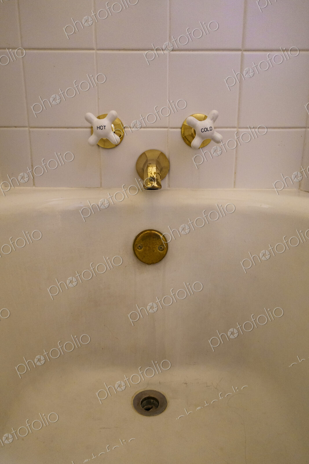 Close-up of old-fashioned bathtub faucet and drain