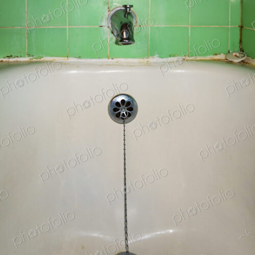Close-up of old-fashioned bathtub faucet and drain Close-up of old-fashioned bathtub faucet and drain