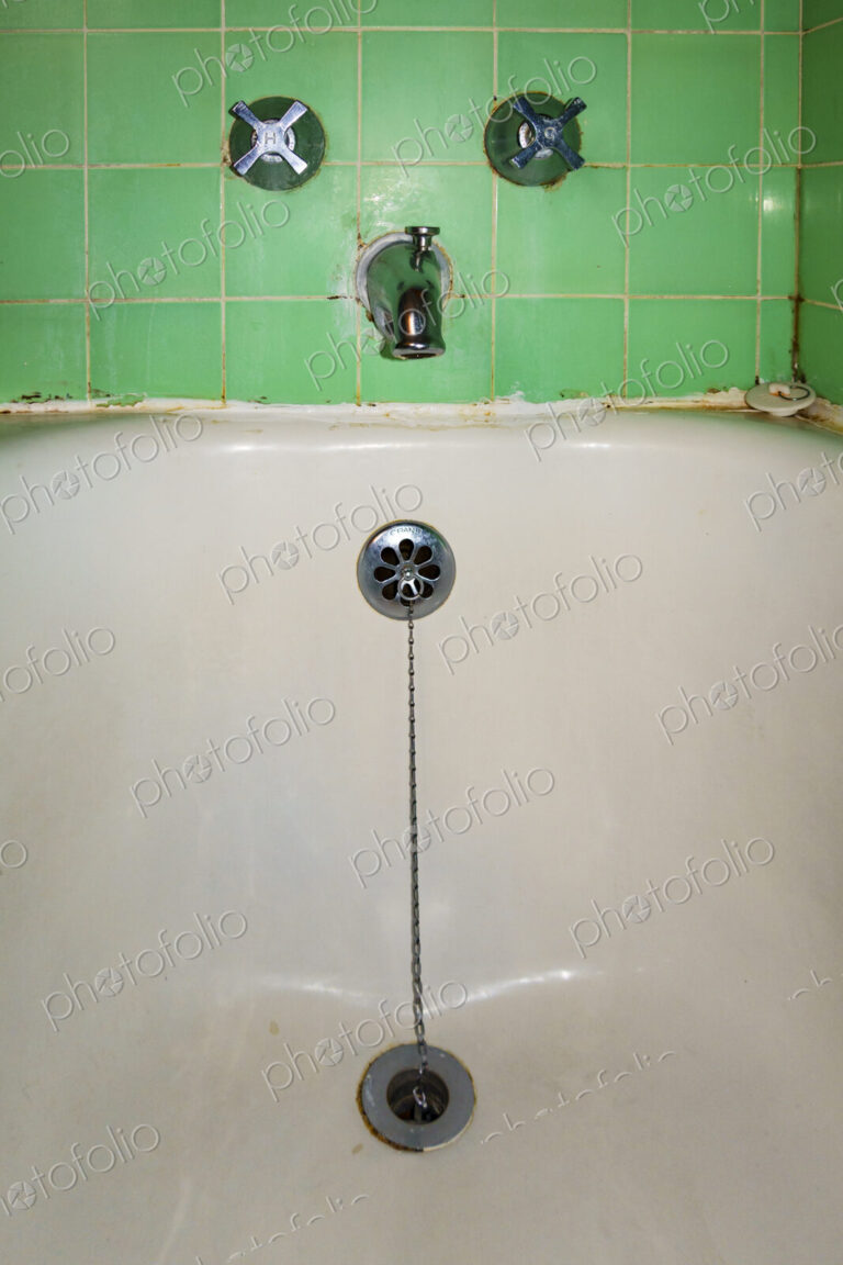 Close-up of old-fashioned bathtub faucet and drain