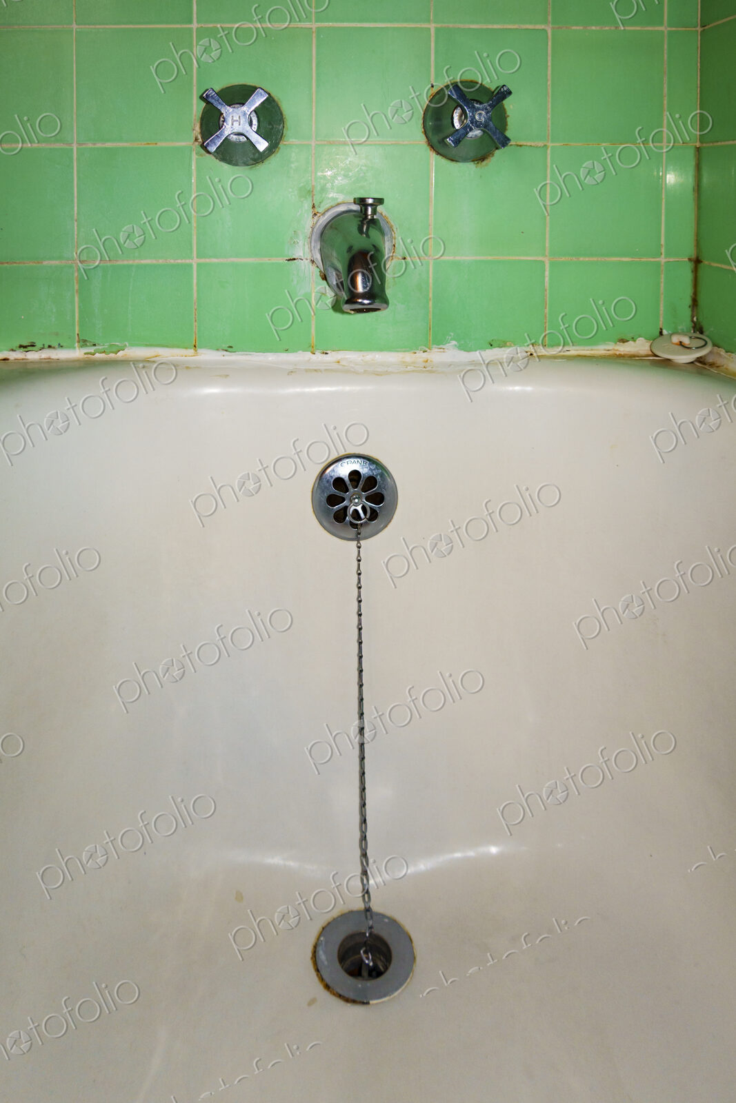 Close-up of old-fashioned bathtub faucet and drain