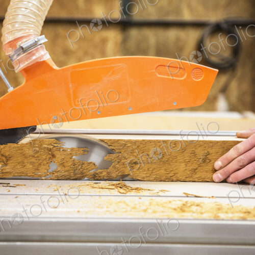 Close up of person cutting piece of recycled wood with a circular saw. Close up of person cutting piece of recycled wood with a circular saw.
