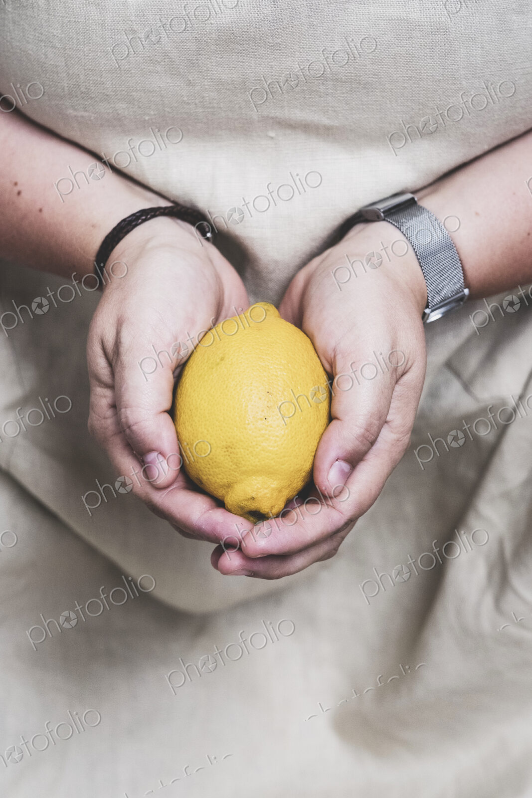 Close up of person holding fresh lemon.