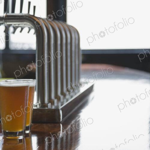 Close up of pints of beer on empty bar counter