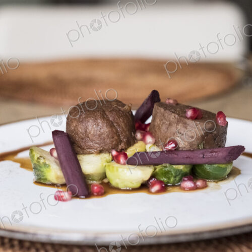 Close up of plate of food, beef with Brussels Sprouts and beetroot and a garnish of… Close up of plate of food, beef with Brussels Sprouts and beetroot and a garnish of…