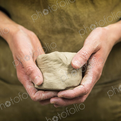 Close up of potter holding piece of pottery clay. Close up of potter holding piece of pottery clay.