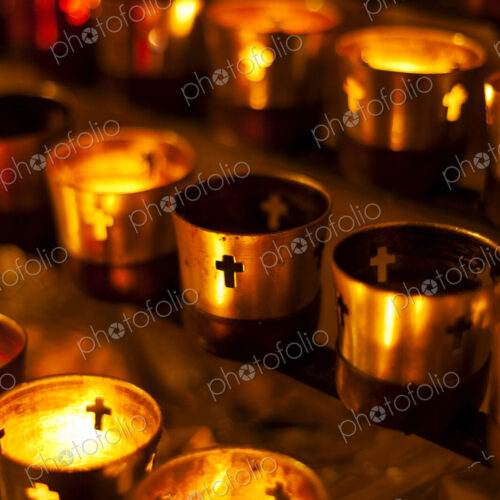 Close up of prayer candles glowing in church