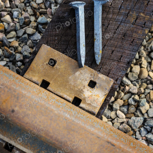 Close up of railroad tracks and rail spikes Close up of railroad tracks and rail spikes