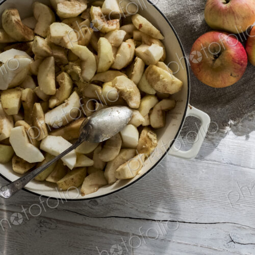 Close up of round baking tin with apple slices. Close up of round baking tin with apple slices.