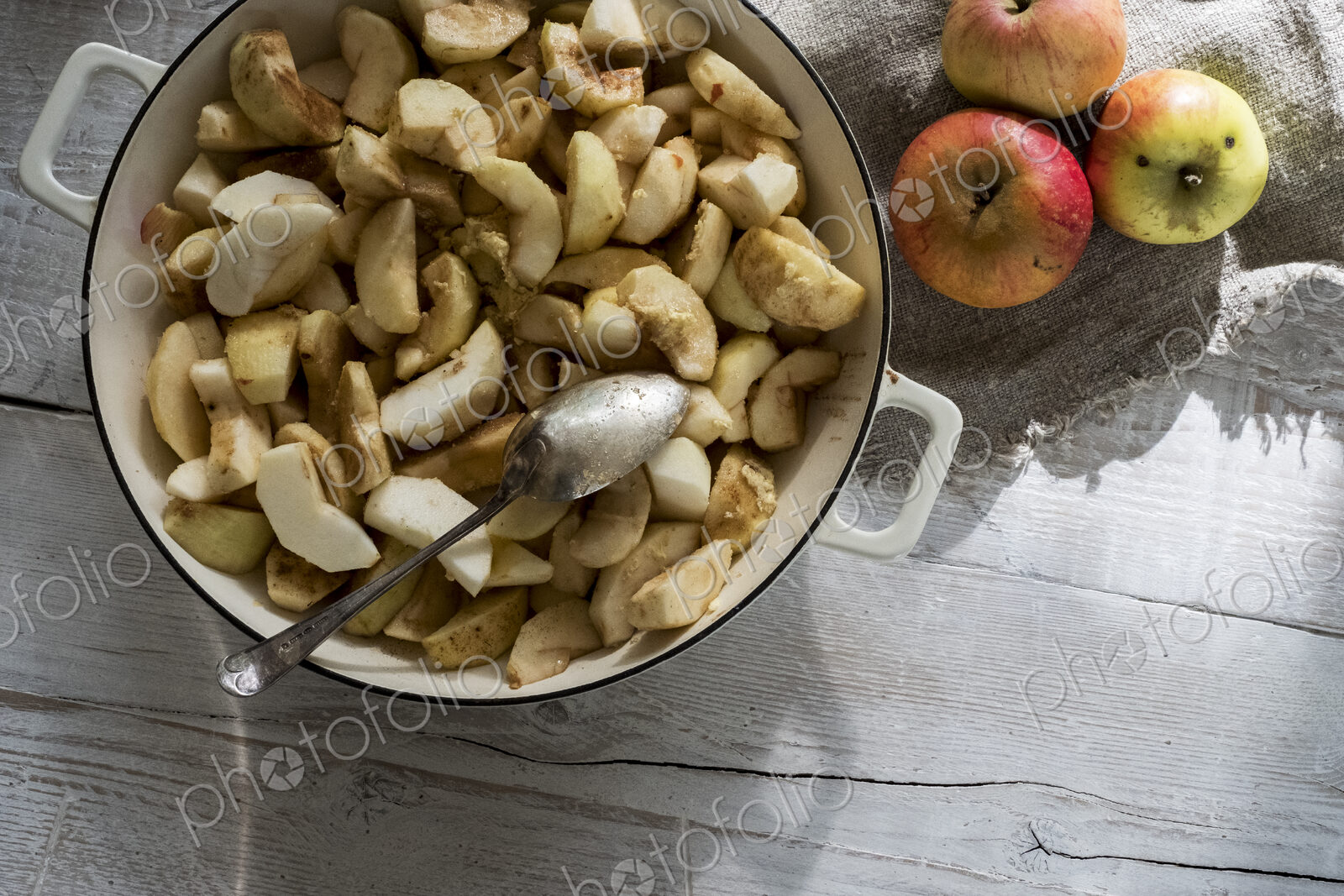 Close up of round baking tin with apple slices.