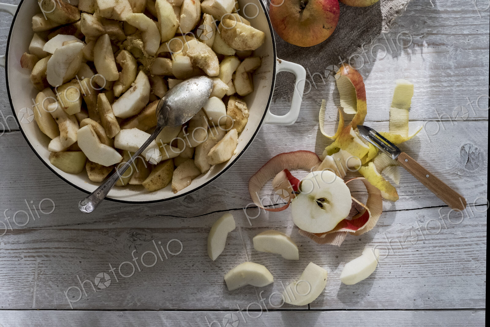 Close up of round baking tin with apple slices.