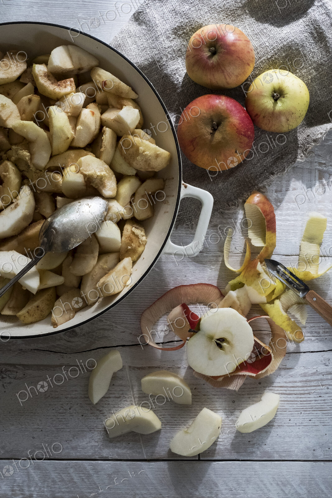 Close up of round baking tin with apple slices.