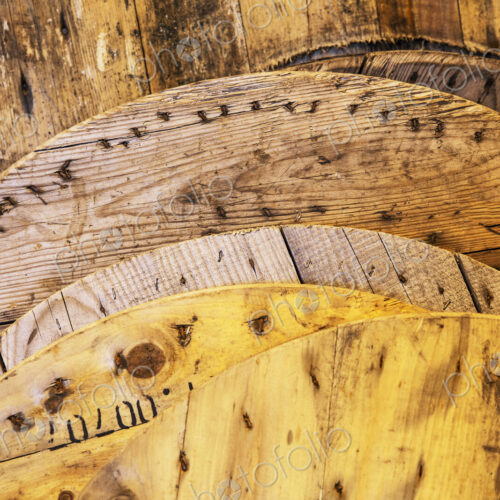 Close up of round lids of recycled wood in a warehouse. Close up of round lids of recycled wood in a warehouse.