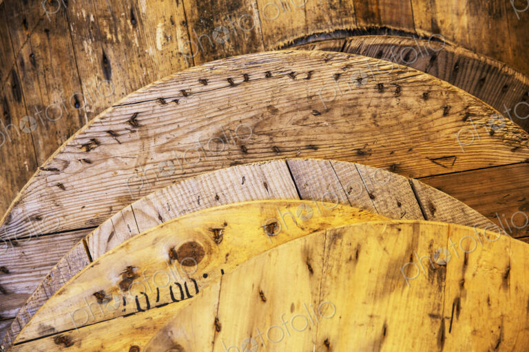Close up of round lids of recycled wood in a warehouse.