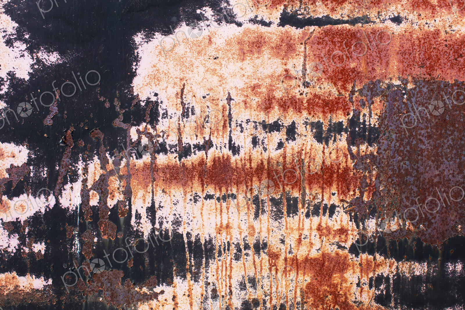 Close up of rusty black and white wall with scratch marks.