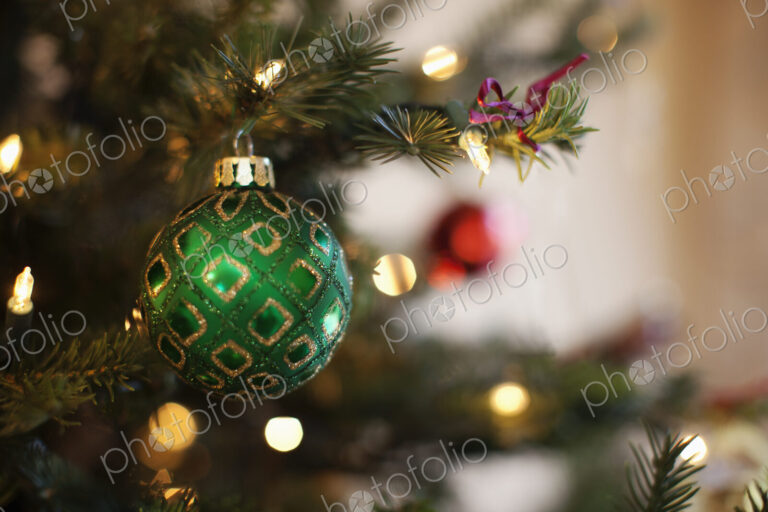 Close up of shiny green and red Christmas tree decorations,