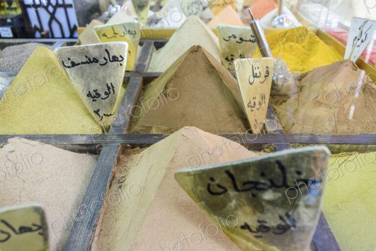Close up of spices, powders heaped up at a market stall in a Jordanian street market.