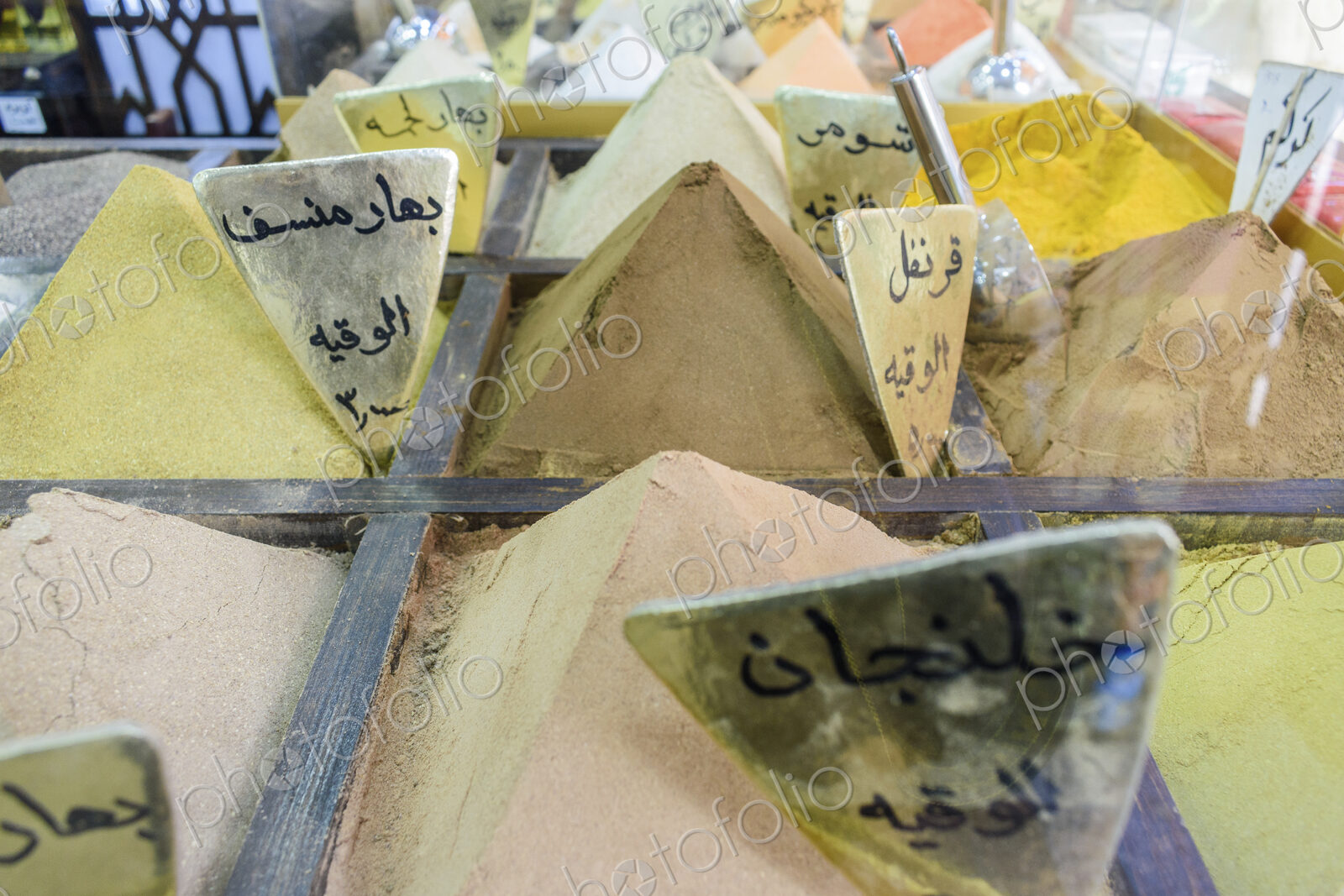 Close up of spices, powders heaped up at a market stall in a Jordanian street market.