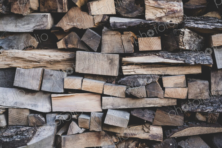 Close up of stack of wooden logs.