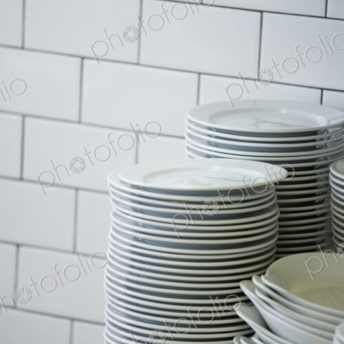 Close up of stacked plates in restaurant kitchen Close up of stacked plates in restaurant kitchen
