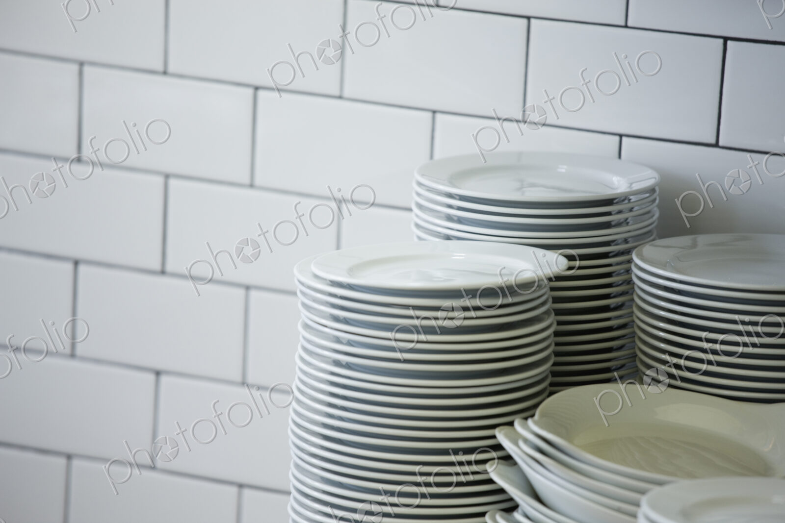 Close up of stacked plates in restaurant kitchen