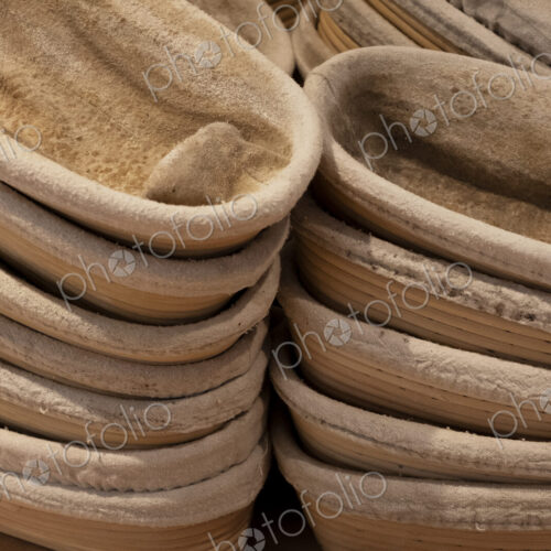 Close up of stacks of proving baskets in an artisan bakery.