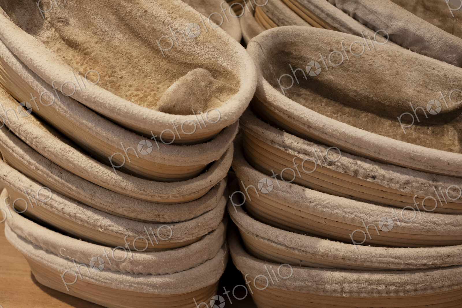 Close up of stacks of proving baskets in an artisan bakery.