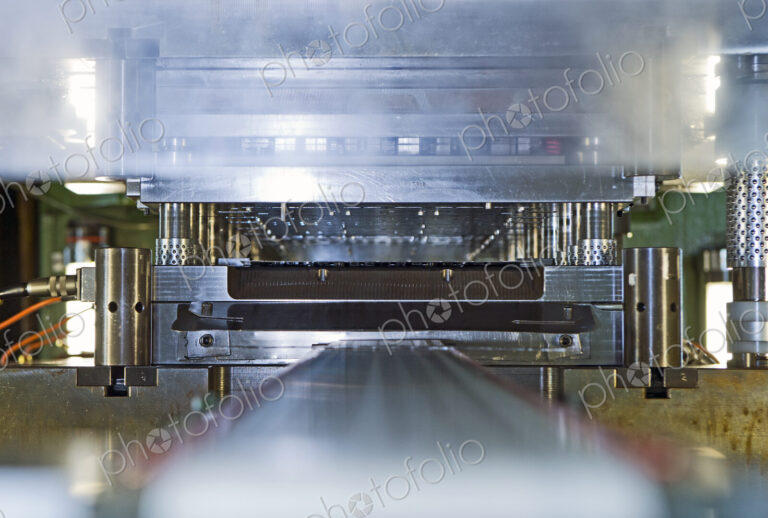 Close up of stamping and pressing machinery