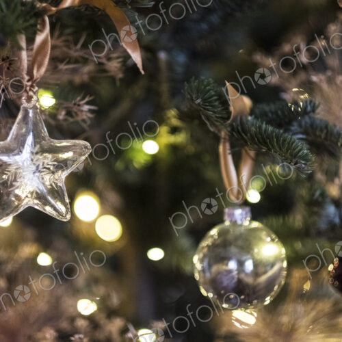 Close up of star shaped glass ornament and bauble on Christmas Tree. Close up of star shaped glass ornament and bauble on Christmas Tree.