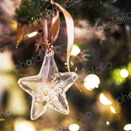 Close up of star shaped glass ornament on Christmas Tree. Close up of star shaped glass ornament on Christmas Tree.