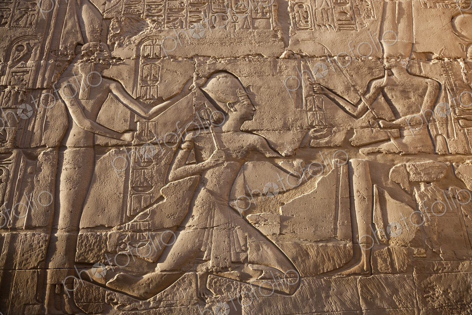 Close up of stone wall with ancient Egyptian bas-relief depicting Pharaoh.