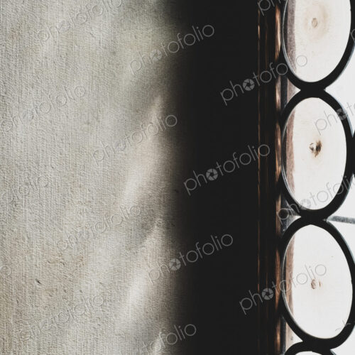 Close up of sunlight reflecting onto a wall through a leaded glass window.