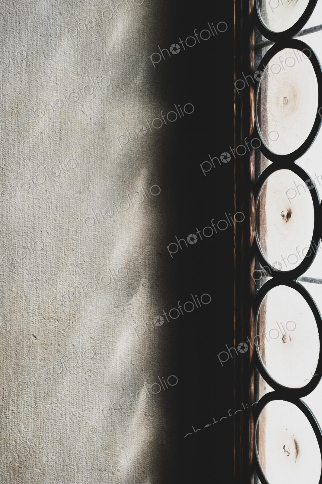 Close up of sunlight reflecting onto a wall through a leaded glass window.