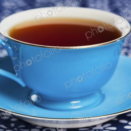 Close up of tea in a blue porcelain teacup with matching saucer. Close up of tea in a blue porcelain teacup with matching saucer.
