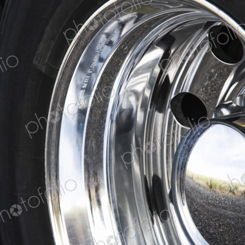 Close up of the chrome hub cap on a commercial truck tire. Close up of the chrome hub cap on a commercial truck tire.