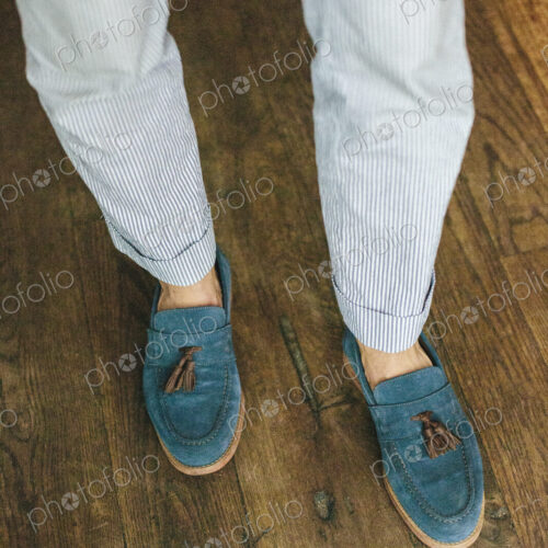 Close up of the legs and feet of a staff member at a city restaurant.
