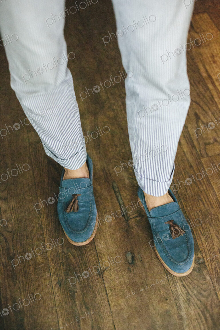 Close up of the legs and feet of a staff member at a city restaurant.