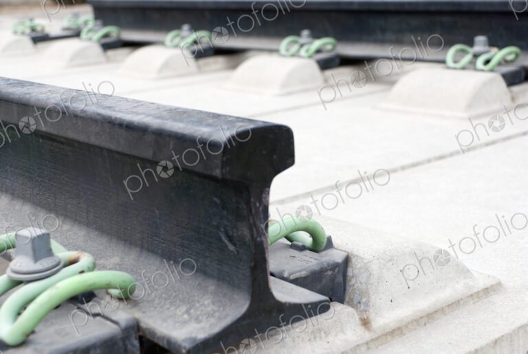 Close up of the metalwork of railway tracks, pinions and sleepers.