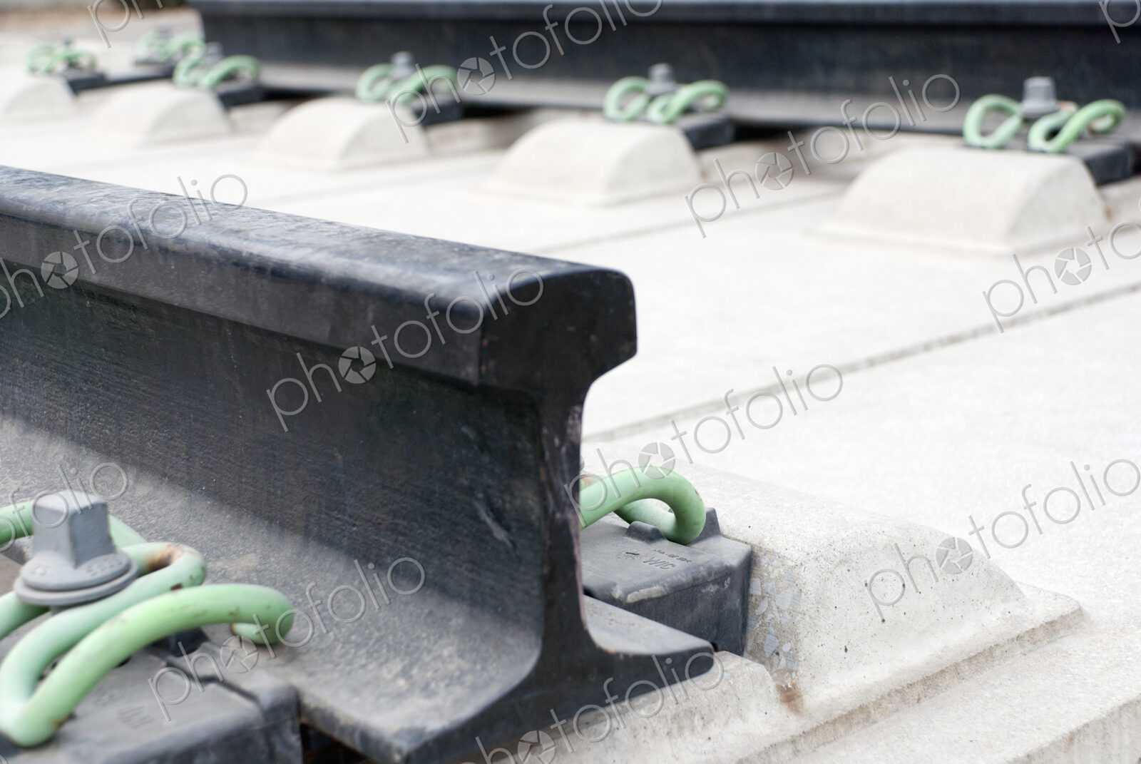 Close up of the metalwork of railway tracks, pinions and sleepers.