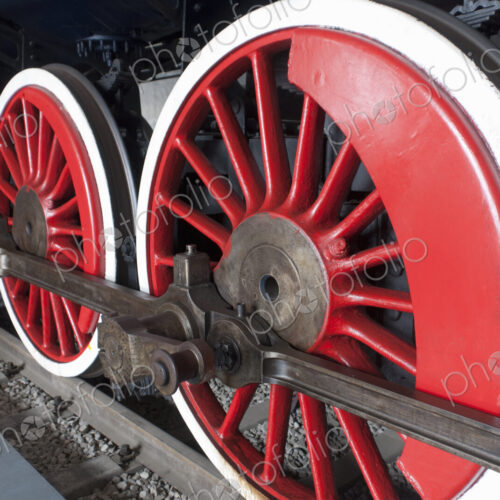 Close up of the rows of steel wheels of a locomotive steam train. Close up of the rows of steel wheels of a locomotive steam train.