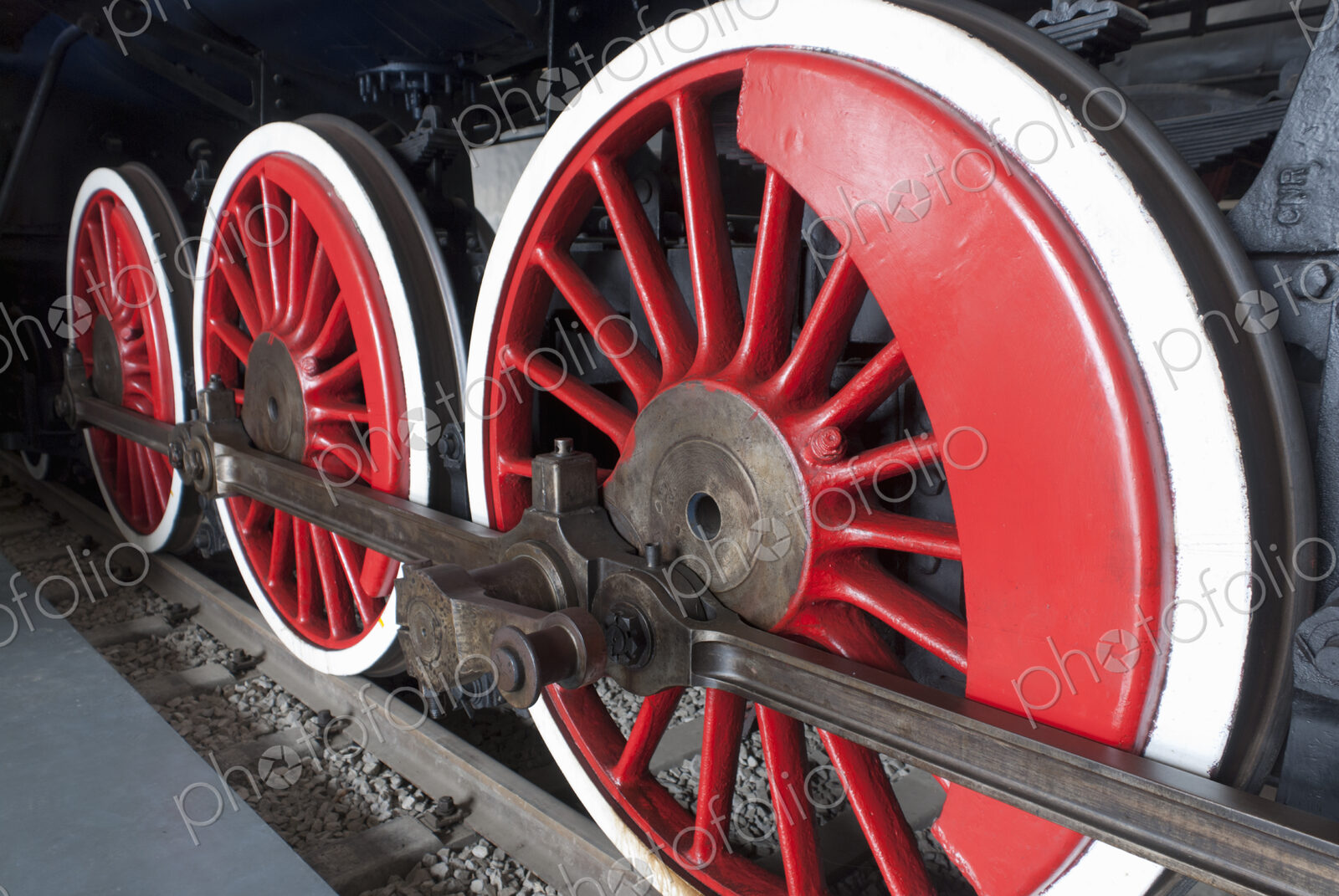 Close up of the rows of steel wheels of a locomotive steam train.