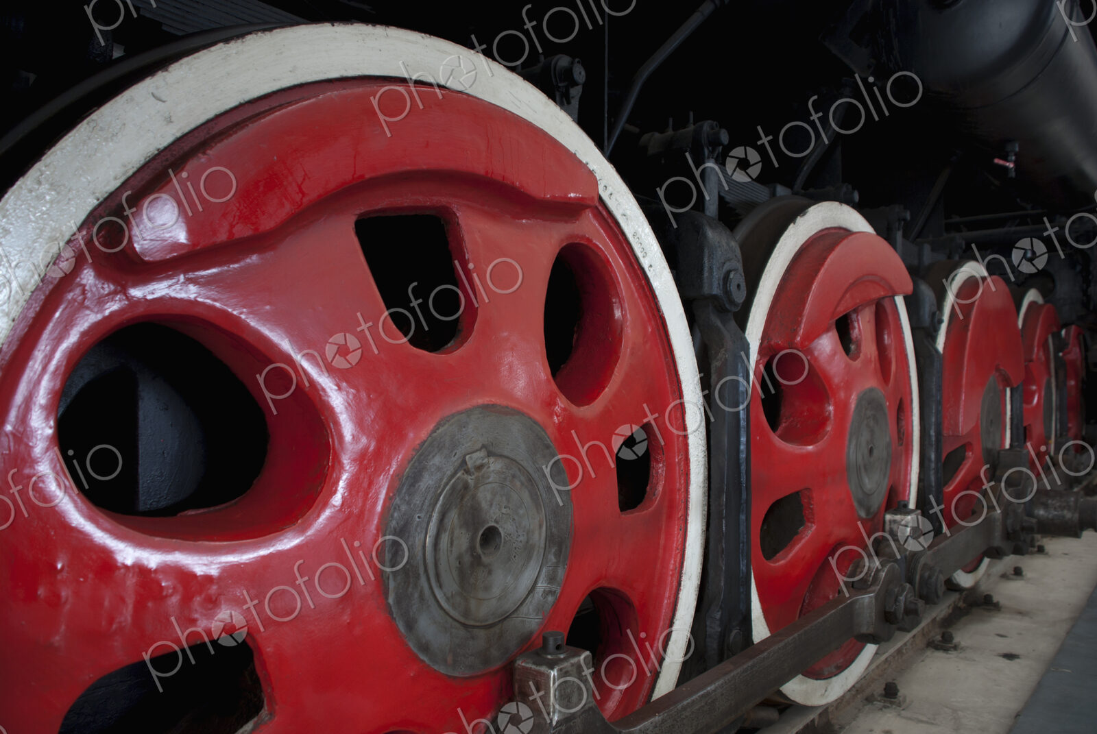 Close up of the rows of steel wheels of a locomotive steam train.