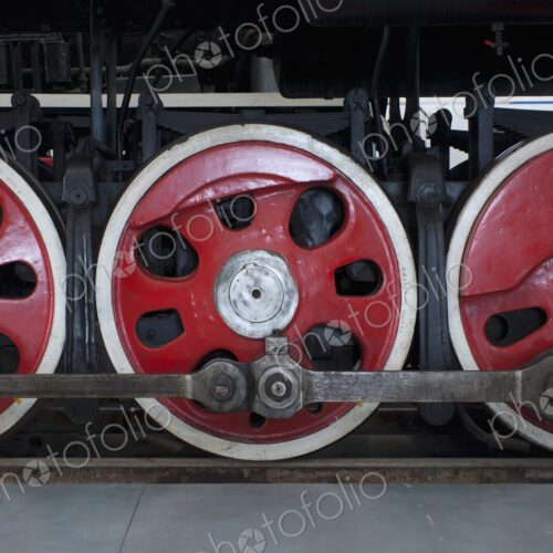 Close up of the rows of steel wheels of a locomotive steam train. Close up of the rows of steel wheels of a locomotive steam train.