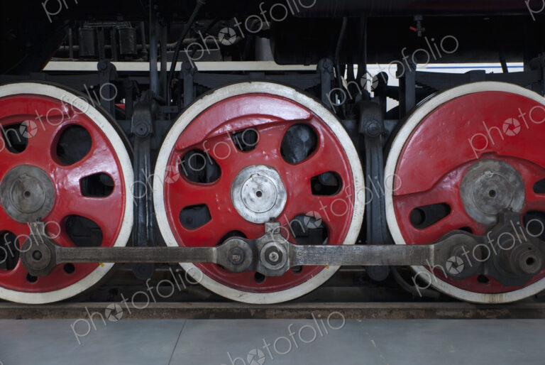 Close up of the rows of steel wheels of a locomotive steam train.