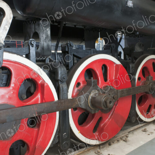 Close up of the rows of steel wheels of a locomotive steam train. Close up of the rows of steel wheels of a locomotive steam train.