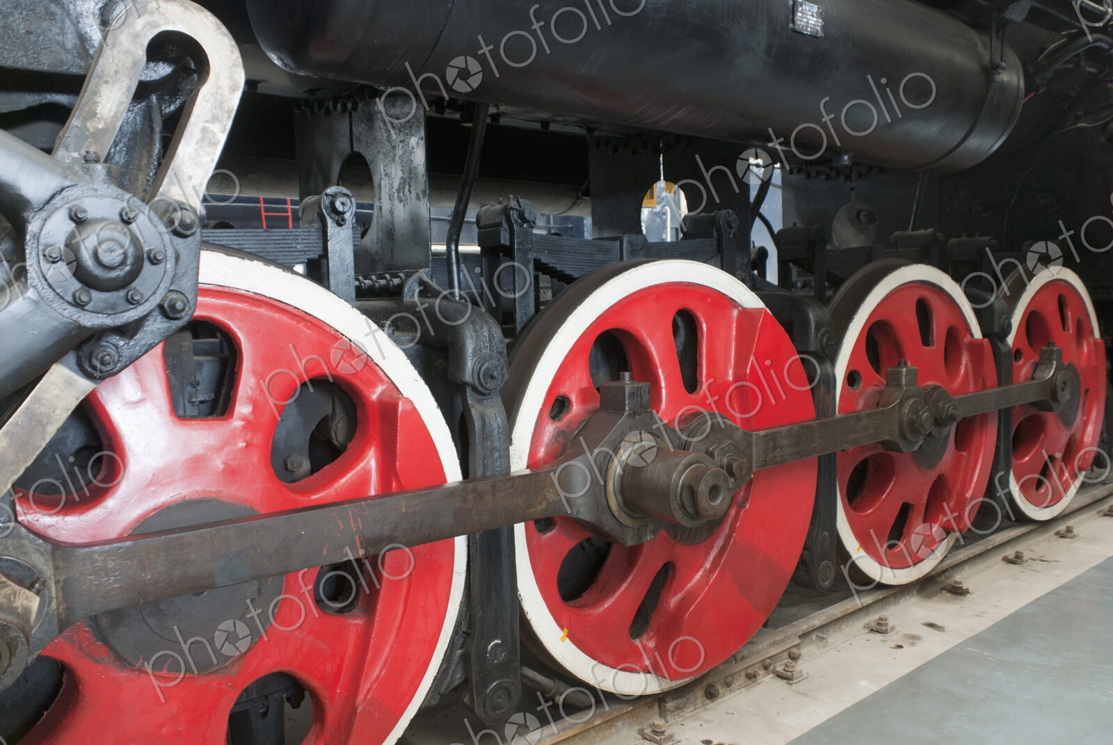 Close up of the rows of steel wheels of a locomotive steam train.