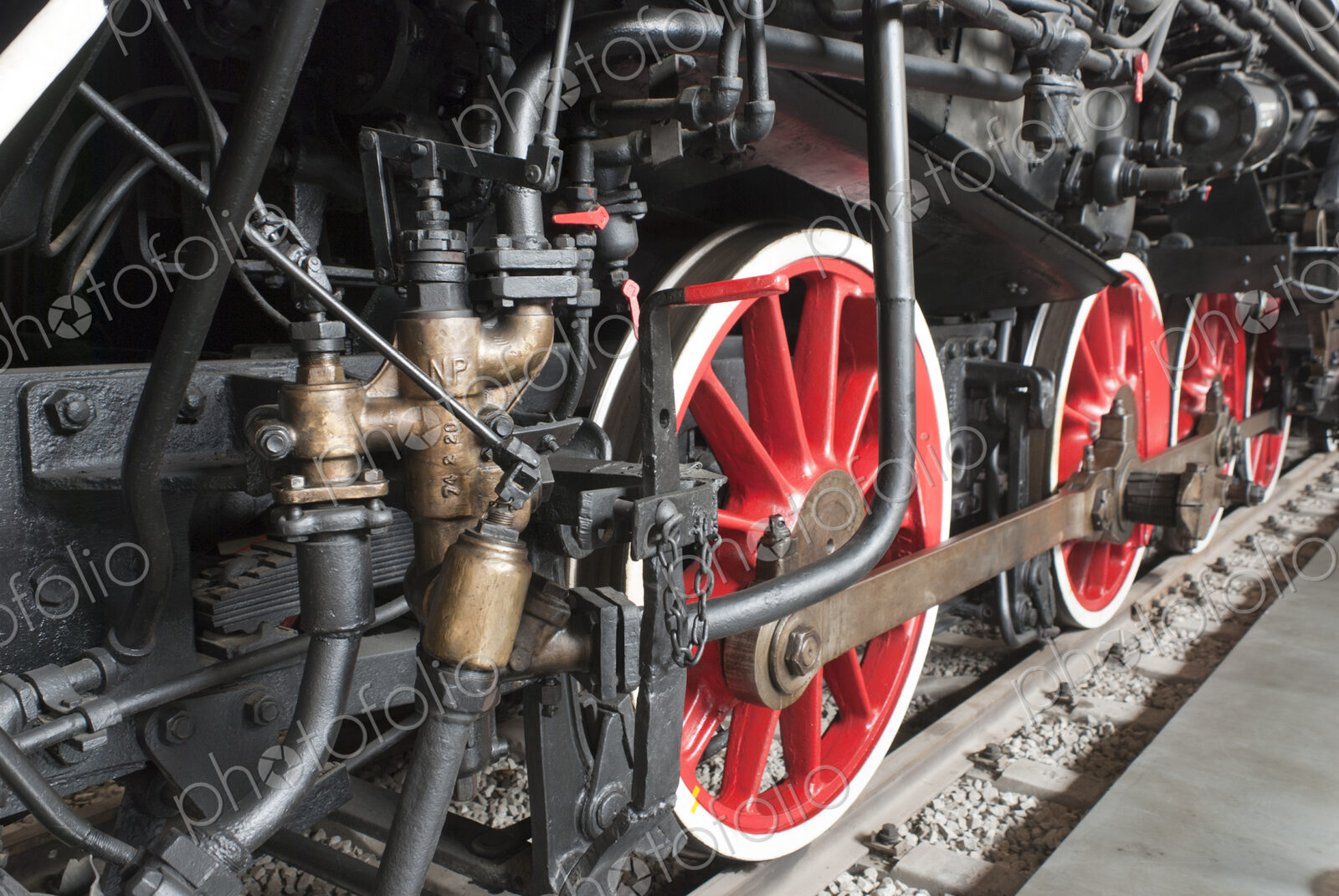 Close up of the rows of steel wheels of a locomotive train on a railway track.