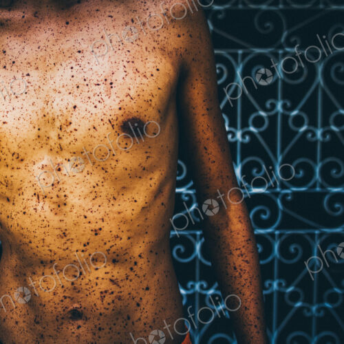 Close up of torso splattered with blood at a religious festival. Close up of torso splattered with blood at a religious festival.